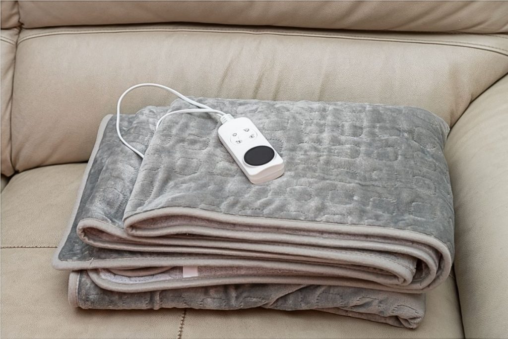 Electric blanket folded on sofa. 