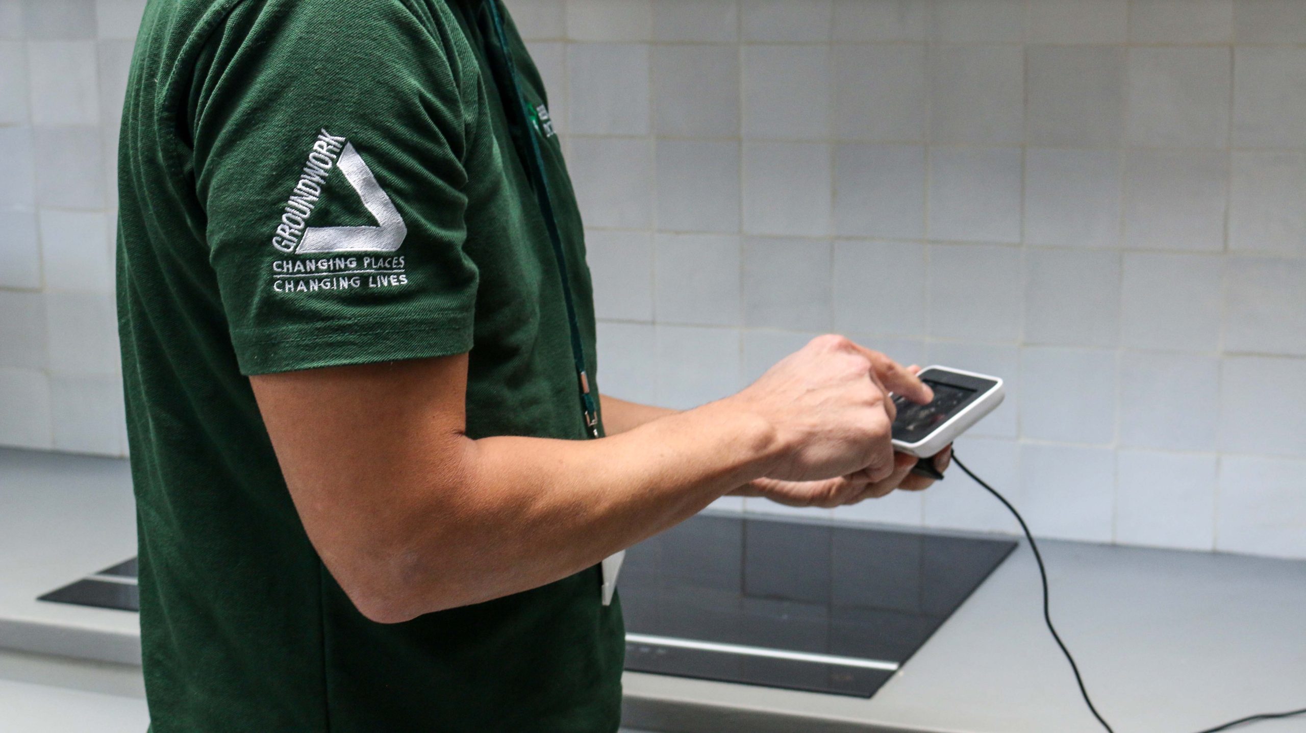 Green Doctor with Groundwork logo on a green polo. As well as a green doctors logo and green lanyard. This helps show the uniform a green doctor will be wearing for your visit, keeping you safe.