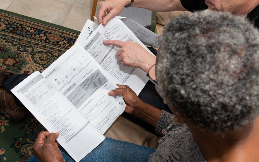 Person reading energy bills showing how Green Doctors can help you understand your energy bills during an energy crisis.