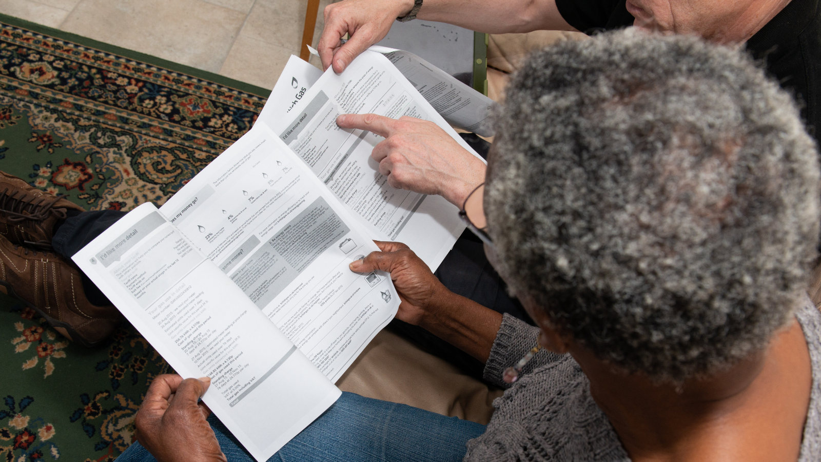 Person reading energy bills showing how Green Doctors can help you understand your energy bills during an energy crisis.