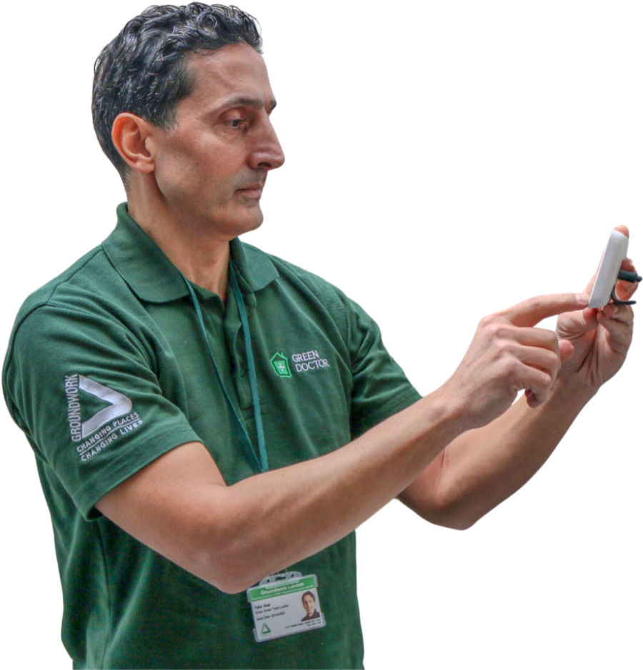 Green Doctor looking at smart meter White background Green Doctor looking at smart meter White background